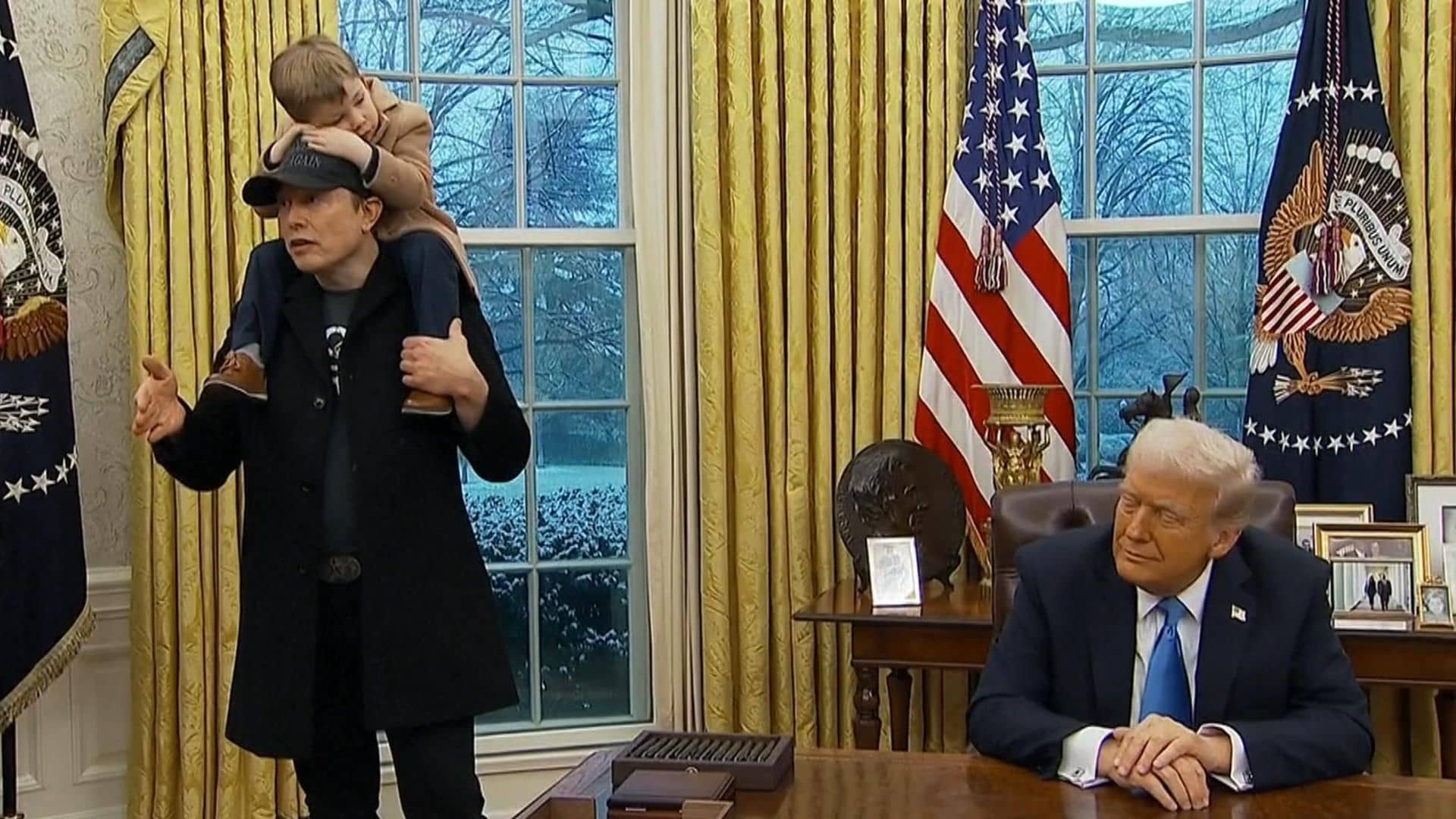 Musk denies ‘hostile takeover’ of US government – as son sits on his shoulders in Oval Office